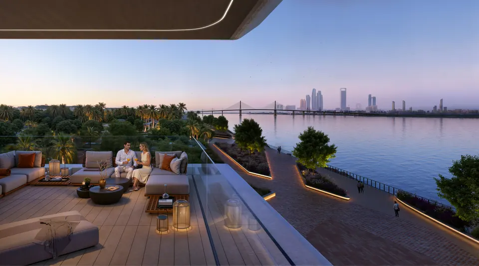 Bashayer Residences: apartment terrace with lounge seating at dusk, developer render