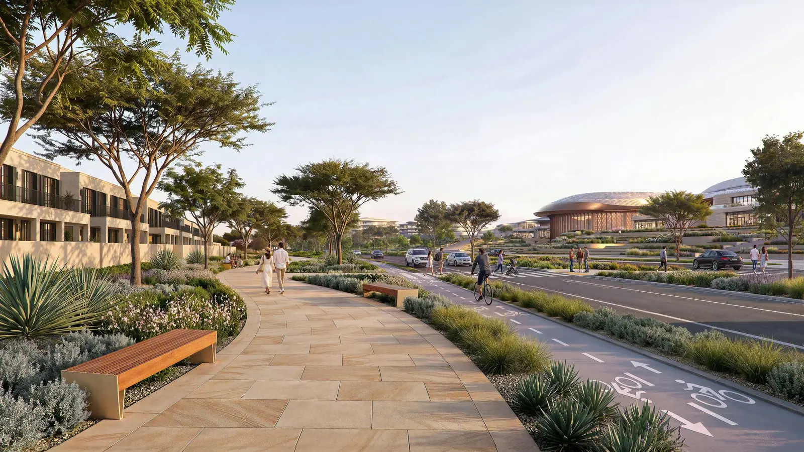 Wadeem Gardens: landscaped footpath and cycle lane beside the road, with homes on one side and the domed arena ahead, developer render