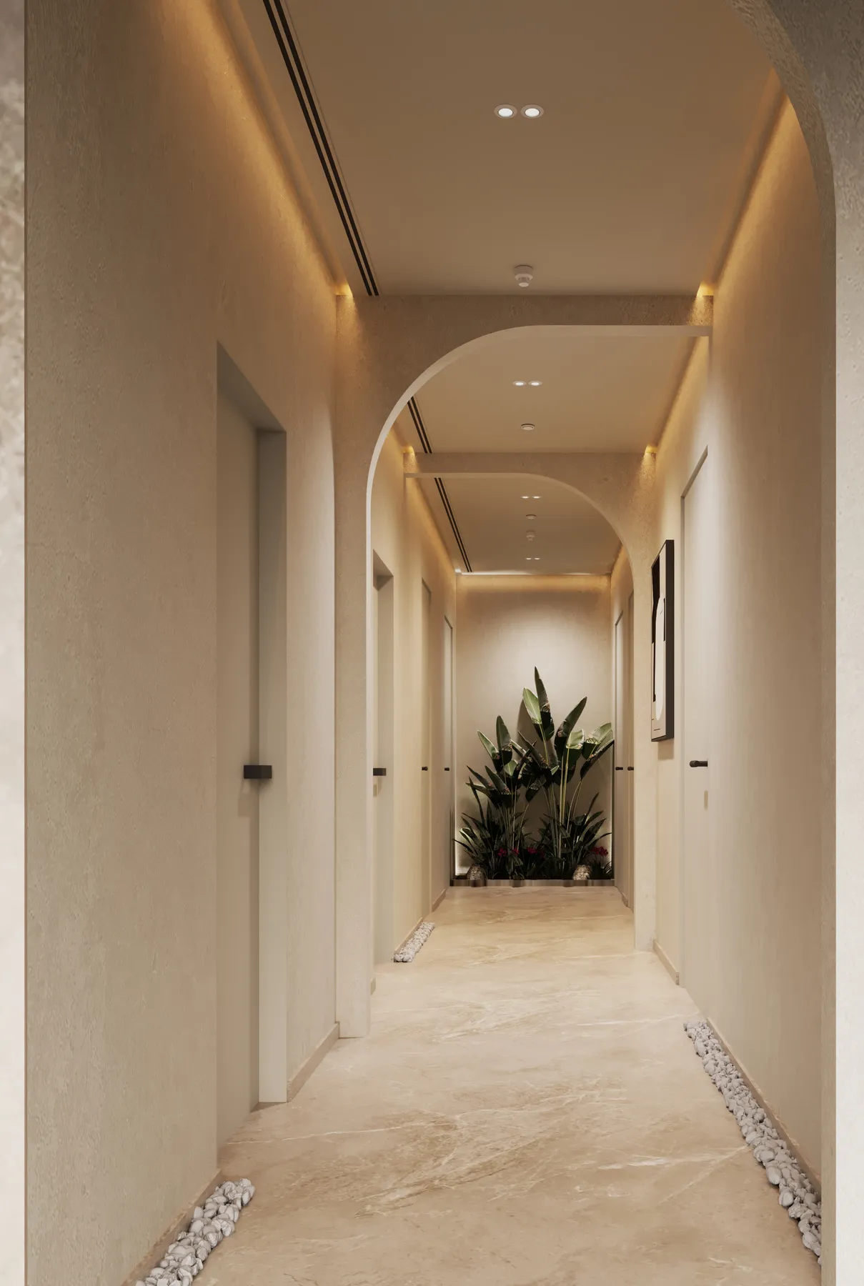 An arched spa corridor lined with pebbles, lit from above, with treatment room doors and planting at the end