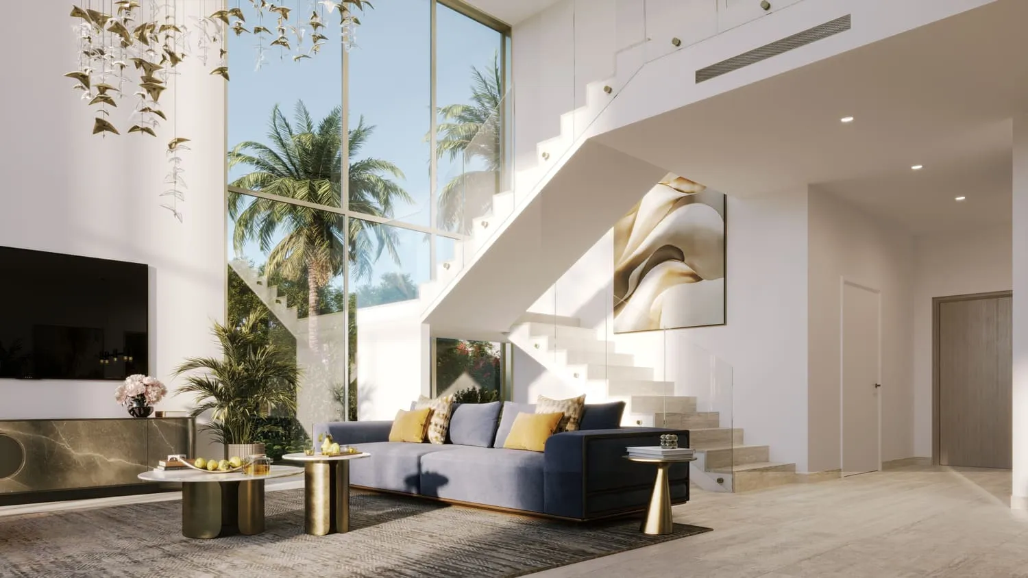 A double-height living room: a navy sofa, a staircase rising past tall glazing, palms outside and a hanging light sculpture