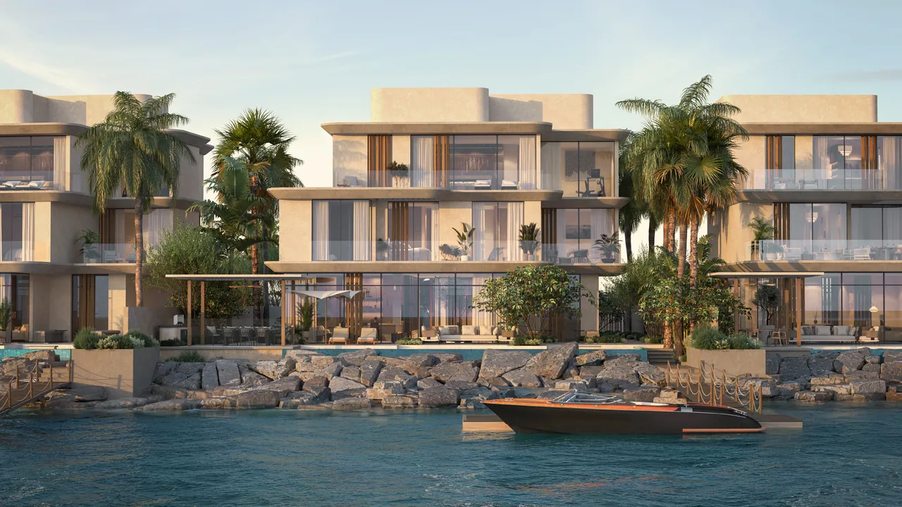 The four-bedroom villa from the water: three storeys of glass and stone between palms, a boat at its dock